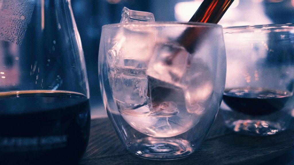 clear drinking glass with ice cubes